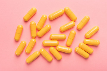 Yellow medical capsule and pills