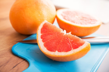 Naklejka na ściany i meble Closeup of sliced juicy grapefruit pieces