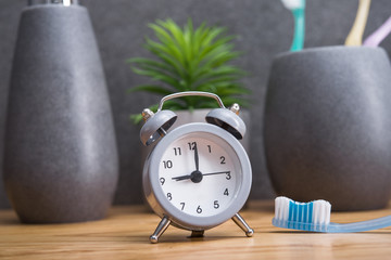 Toothbrush in holder with clock