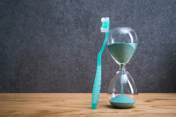 Toothbrushs with hourglass on a bathroom table