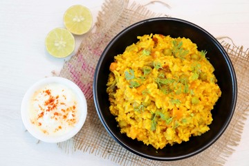 Dal khichadi or Masala Khichdi is a Tasty Indian recipe made of mixed Lentils & rice combined with onions, garlic, tomatoes, Carrots, Peas, cauliflower and beans. Served with Curd or Yogurt & lemon 
