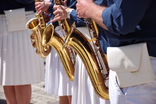 Midsection of brass band playing music outside