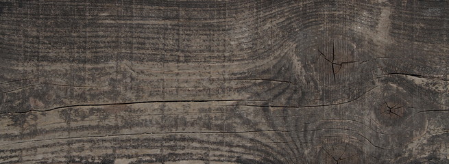 ein altes braunes Holzbrett mit einem Astloch