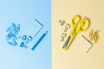 Stationery on blue and yellow background. Back to school concept.