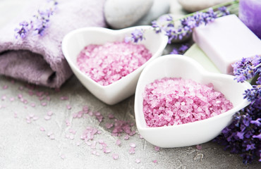 Fototapeta na wymiar Heart-shaped bowl with sea salt, soap and lavender flowers