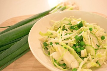 Healthy meal, white cabbage, cucumber, peas and green onion salad.