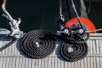 Two black ropes on the sea pier