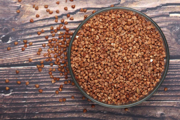 A glass bowl with raw buckwheat	