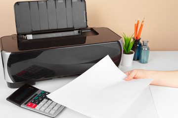 Woman using the printer to scanning and printing document