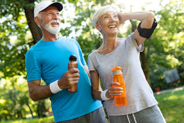 Senior couple staying hydrated after running jogging