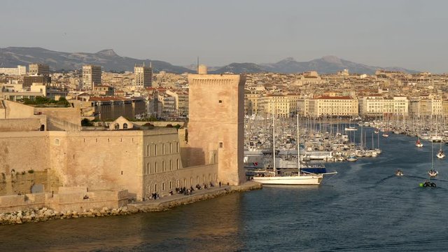 Marseille, France. Boats sailing by the Old Port of Marseille. A tower of Fort Saint-Jean is seen in this shot. The Fort was built by Louis IV in 1660 at the former site of Order of the Knights