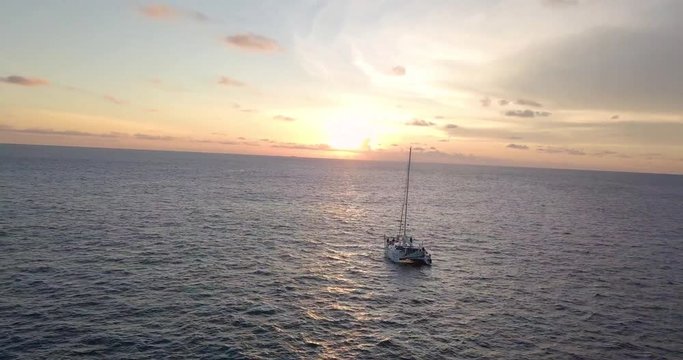 yacht in a sea in front of sunset near Phuket, Thailand, clear sky and calm water