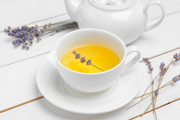 teapot and cups of tea on a white wooden background