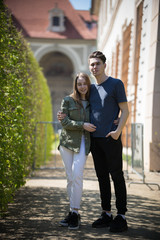 A young couple traveling. Standing on the street and hug