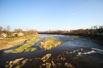 Beautiful view countryside waterfall with fish flying in river Venta.
