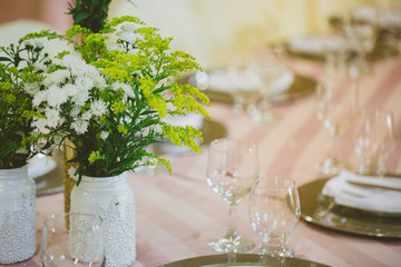 Table decorated for wedding event. Colors golden and white.