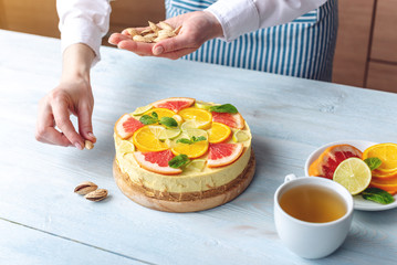Obraz na płótnie Canvas Raw citrus cake with grapefruit, orange, lime and lemon. Healthy fresh summer dessert. Gluten free, no baking vegan food