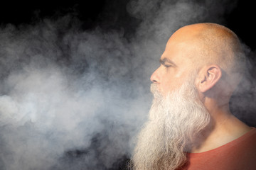 bearded man gets smoke in his face portrait