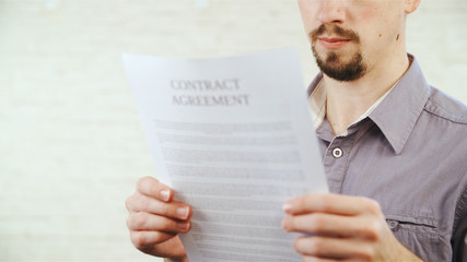 Person reading contract agreement