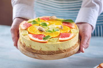 Obraz na płótnie Canvas Raw citrus cake with grapefruit, orange, lime and lemon. Healthy fresh summer dessert. Homemade vegan food