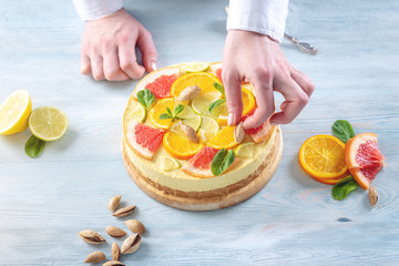 Raw citrus cake with grapefruit, orange, lime and lemon with nuts and mint. Healthy fresh summer dessert
