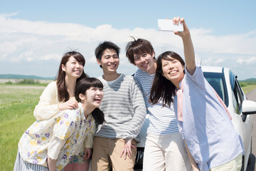 車の周りで写真を撮る大学生