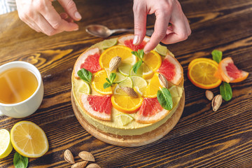 Raw citrus cake with grapefruit, orange, lime and lemon. Cooking healthy summer vegan dessert with vegetable ingredients