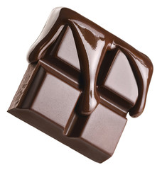 Melted chocolate pours into a piece of chocolate bar isolated on white background.