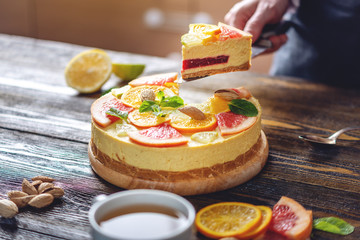 A piece of raw citrus cake with grapefruit, orange, lime and lemon. Cooking healthy summer vegan dessert