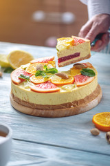 A piece of raw citrus cake with grapefruit, orange, lime and lemon. Healthy fresh summer dessert. Homemade vegan food