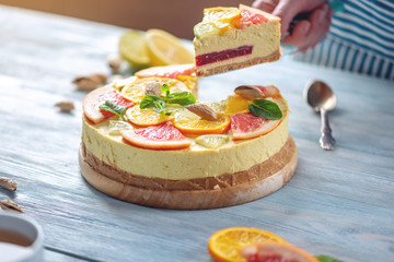 A piece of raw citrus cake with grapefruit, orange, lime and lemon. Healthy fresh summer dessert....
