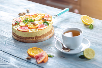 Raw citrus cake with grapefruit, orange, lime and lemon with nuts and mint. Fresh summer dessert. Gluten free vegan food
