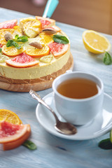 Raw citrus cake with grapefruit, orange, lime and lemon with nuts and mint. Fresh summer dessert. Gluten free vegan food