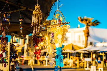 Sunshine view of handmade jewelry and souvenirs on the background of island's street