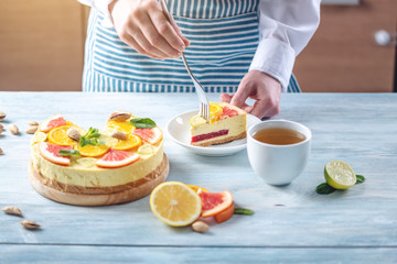 Obraz na płótnie Canvas A piece of raw citrus cake with grapefruit, orange, lime and lemon. Fresh summer dessert. Gluten free vegan food