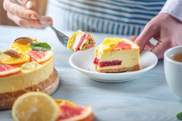 Piece of raw citrus cake with grapefruit, orange, lime and lemon. Cooking at home healthy summer vegan dessert