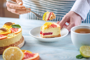 Piece of raw citrus cake with grapefruit, orange, lime and lemon. Cooking at home healthy summer vegan dessert