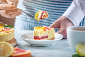Piece of raw citrus cake with grapefruit, orange, lime and lemon. Cooking at home healthy summer vegan dessert