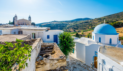 Typical whitewashed church with blue dome on the corner of the street, Lefkes, Paros island, Greece - obrazy, fototapety, plakaty