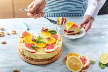 Piece of raw citrus cake with grapefruit, orange, lime and lemon. Cooking at home healthy summer vegan dessert