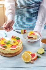 Obraz na płótnie Canvas Raw citrus cake with grapefruit, orange, lime and lemon with nuts and mint. Cooking healthy fresh summer vegan dessert