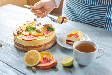 Raw citrus cake with grapefruit, orange, lime and lemon with nuts and mint. Cooking healthy fresh summer vegan dessert