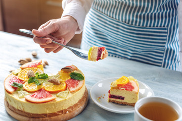 Raw citrus cake with grapefruit, orange, lime and lemon with nuts and mint. Cooking healthy fresh summer vegan dessert