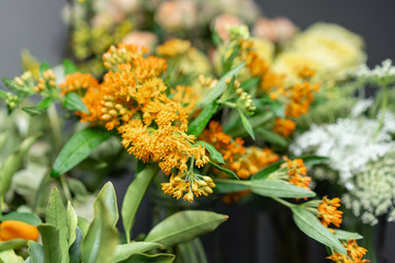 Flower shop concept. Glass vases with different colors on the shelves of the refrigerator showcases. Abstract background of flowers. Flowers composition.