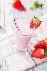 Fresh milk, strawberry, banana on wooden table, assorted protein cocktails with fresh fruits. Natural background.