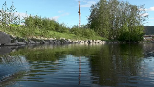 This batch contains several clips from the a sunny day in may in the scandinavian country of Norway. Sun in the trees. Flowers and trees are blooming. Waterfall and the seagulls play on the beach.