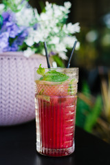 Healthy raspberry smoothie on wooden table with mint leaves
