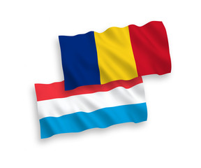 National vector fabric wave flags of Romania and Luxembourg isolated on white background. 1 to 2 proportion.