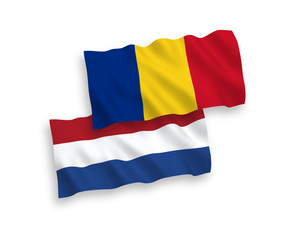 National vector fabric wave flags of Romania and Netherlands isolated on white background. 1 to 2 proportion.