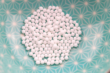 Globuli Kügelchen Detail auf blauen Hintergrun, Homöopathie Gesundheit